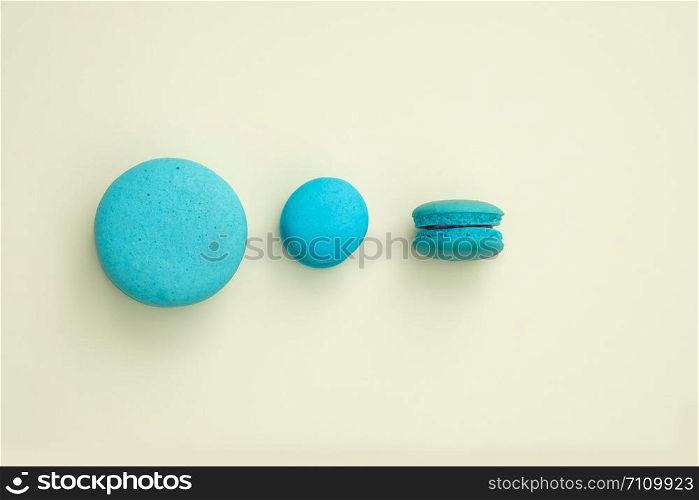 blue macaroon on a yellow background. Top view