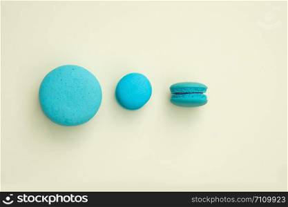 blue macaroon on a yellow background. Top view