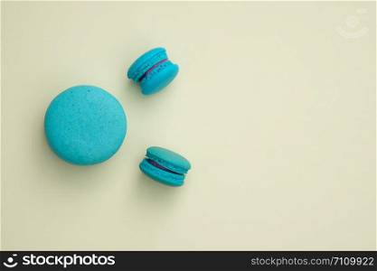 blue macaroon on a yellow background. Top view, Space to write at right.