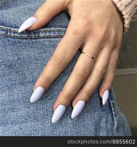 Blue manicure. Hands of a woman with blue manicure on nails.Manicure beauty salon concept. Empty place for text or logo.. Stylish trendy blue female manicure.Hands of a woman with blue manicure on nails