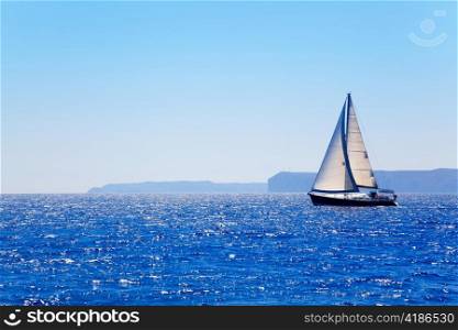 Blue Mediterranean sailboat sailing in perfect ocean at San Antonio cape
