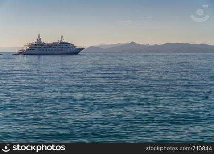 Blue Mediterranean Sea with boat against islands background