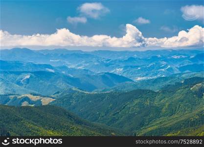 Blue mountains and hills landscape with blue sky and clouds