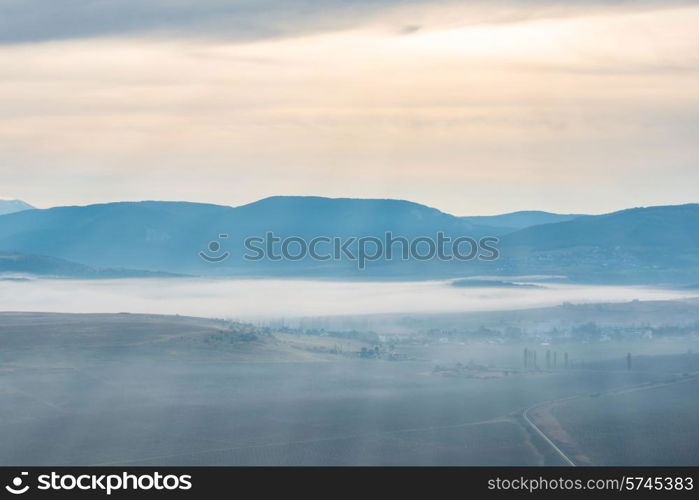 Blue mountains covered with mist against sunset