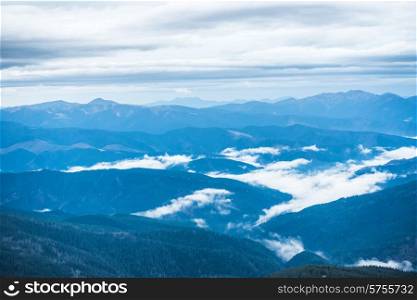 Blue mountains covered with white clouds. Carpathian, Ukraine
