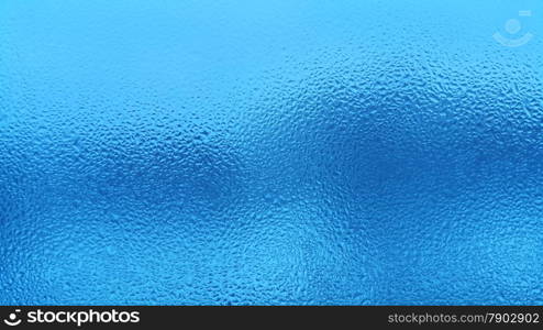 Blue natural background with water drops on glass