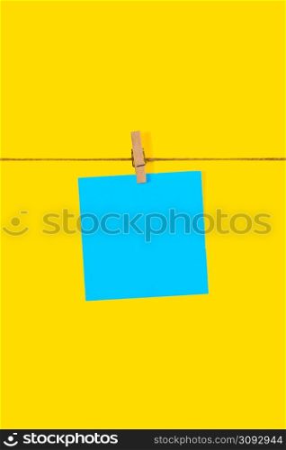 Blue Note papers and decorative pin or clip isolated on yellow background. Office mock up. Top view, flat lay. Colorful office note or sticker papers.. Blue Note papers and decorative pin or clip isolated on yellow background. Office mock up. Top view, flat lay. Colorful office note or sticker papers