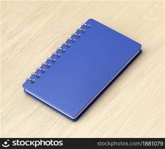 Blue notebook on wooden desk