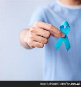 Blue November Prostate Cancer Awareness month, Man in blue shirt with hand holding Blue Ribbon for support people life and illness. Healthcare, International men, Father, Diabetes and World cancer day