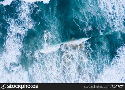 Blue ocean waves and sand aerial drone top view