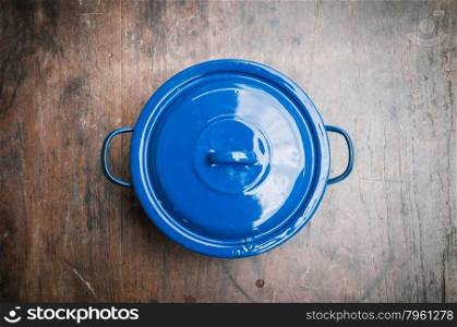 blue of cooking pot on wooden background