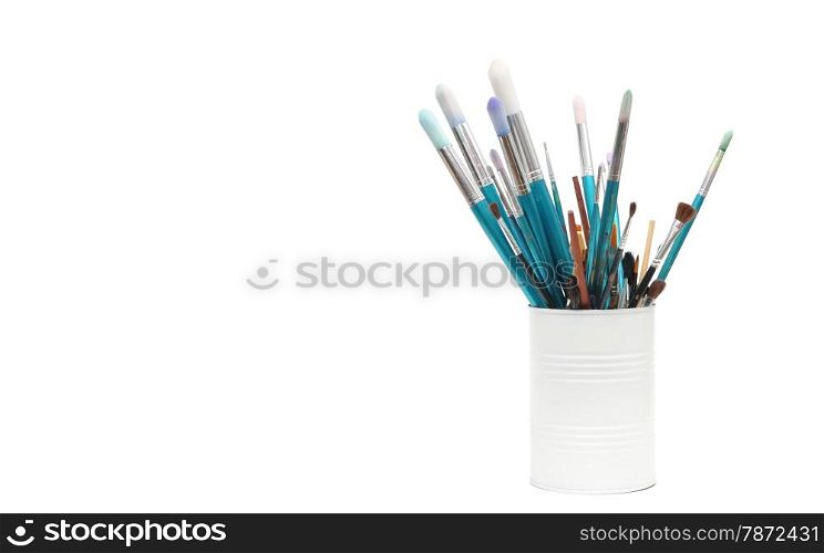 blue paint brushes in cup isolated on white background