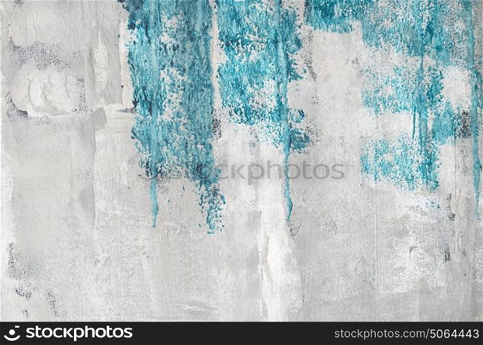 Blue paint on a grunge wall with weathered surface in bright colors