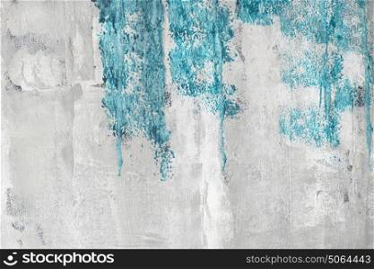 Blue paint on a grunge wall with weathered surface in bright colors