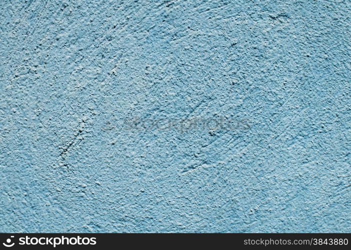 Blue painted plaster house wall closeup as background