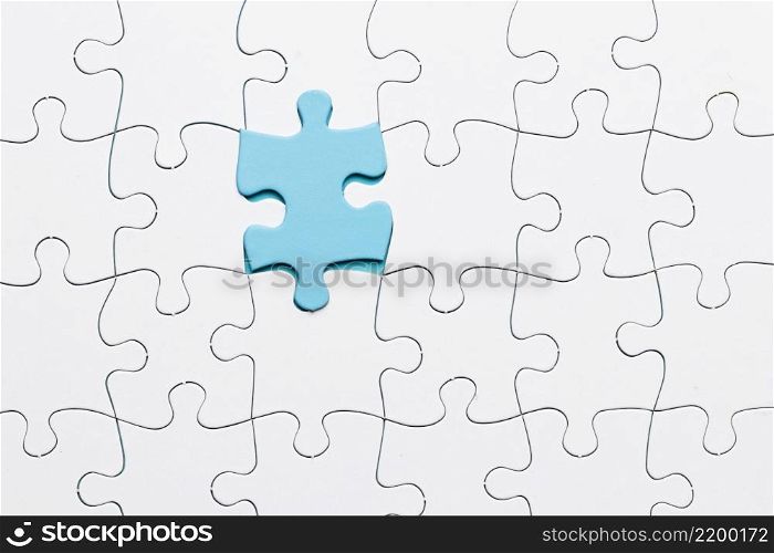 blue piece puzzle connected with white piece backdrop
