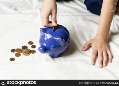 blue piggy bank filled with coins