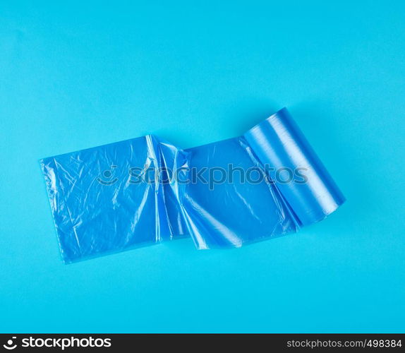 blue plastic bag for garbage on a blue background, top view