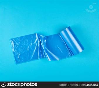 blue plastic bag for garbage on a blue background, top view