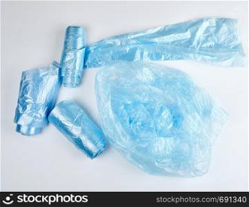 blue plastic bags for garbage on a white background, top view