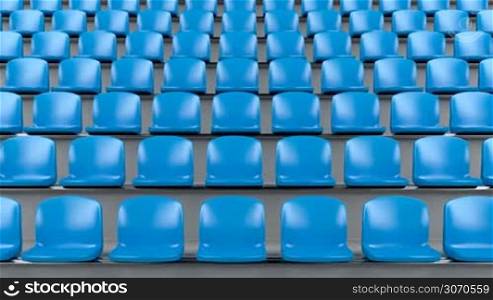 Blue plastic seats at the stadium, camera slide to right