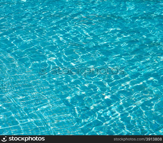 Blue pool water with sun reflections