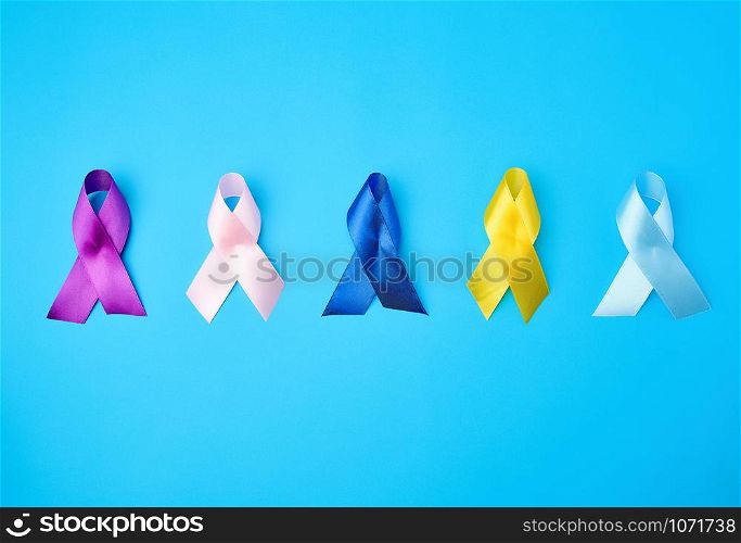 blue, purple, yellow, blue, pink ribbon in the form of a bow, international symbols of diseases on a blue background