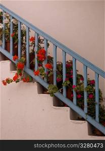 Blue rail and flowers in Mykonos Greece