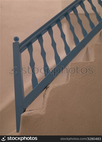 Blue railing on staircase in Mydonos Greece