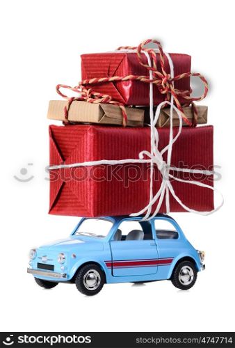 Blue retro toy car delivering Christmas or New Year gifts, isolated on white