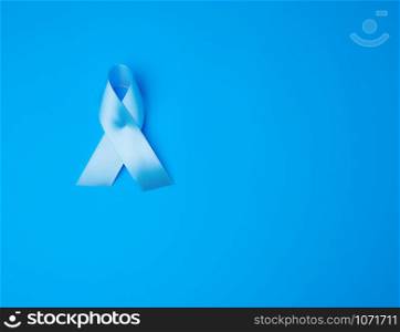 blue ribbon, symbol of the fight and treatment of prostate cancer, copy space