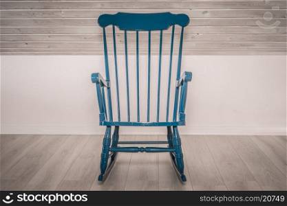 Blue rocking chair on a wooden floor
