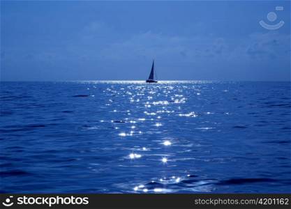 blue sailboat sailing mediterranean sea with water horizon
