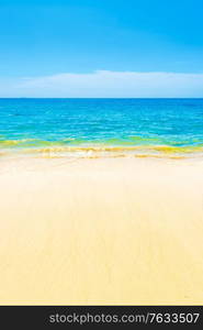 Blue sea blue water and sand beach with blue sky as summer holiday vacation background