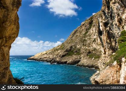 blue sea of the island of Gozo in Malta. the rugged coastline of the island of Gozo are reflected in a blue sea