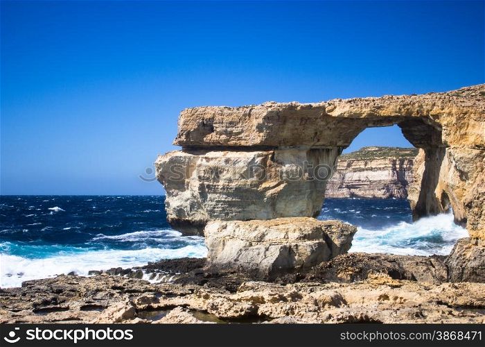 blue sea of the island of Gozo in Malta. the rugged coastline of the island of Gozo are reflected in a blue sea
