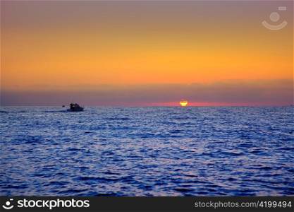blue sea sunrise with sun in horizon with fishing boat sailing