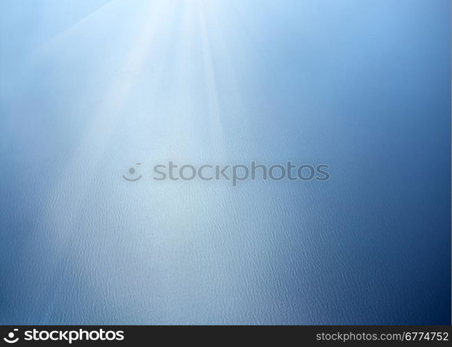 Blue sea surface with waves and sun lights