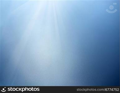 Blue sea surface with waves and sun lights
