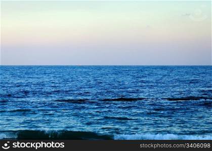 blue sea, the horizon, a iridescent sky, ship on the horizon