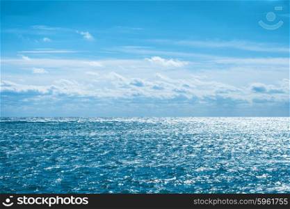 Blue sea with sky and clouds. Water natural background