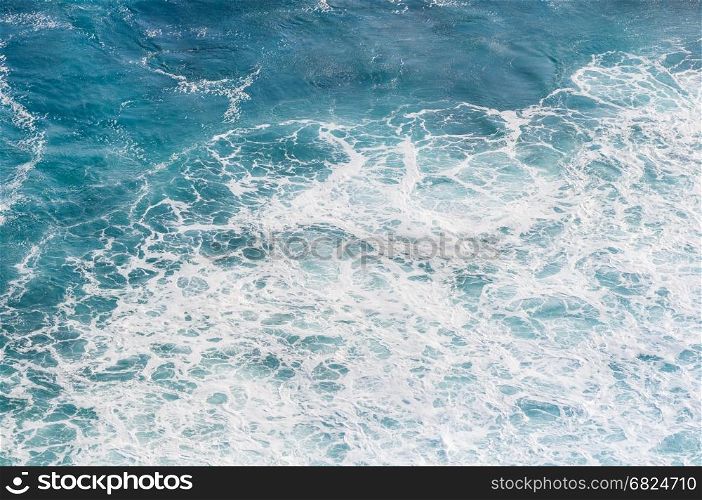 Blue sea with waves and foam