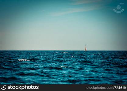Blue seascape, idyllic shot of calm sea water and warning buoy. Marine objects concept.. Calm sea water and warning buoy