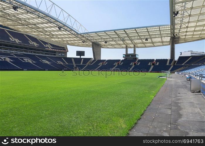 Blue Seatings, Green Pitch, Gallery and Glass Benches inside Empty Stadium Before Soccer Match.. Blue Seatings, Green Pitch, Gallery and Glass Benches inside Empty Stadium Before Soccer Match