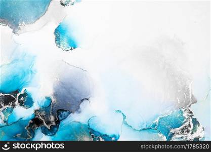 Blue silver abstract background of marble liquid ink art painting on paper . Image of original artwork watercolor alcohol ink paint on high quality paper texture .. Blue silver abstract background of marble liquid ink art painting on paper .