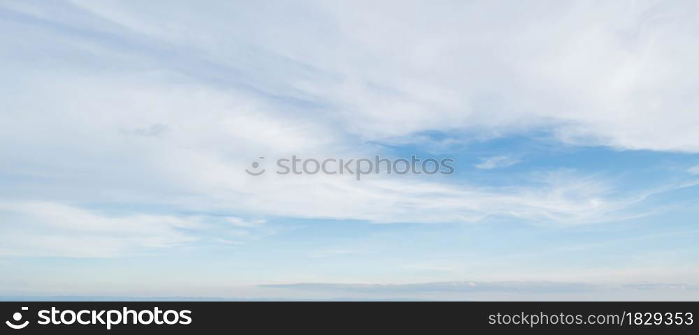 Blue sky against soft white clouds. Beautiful natural cloudscape background.