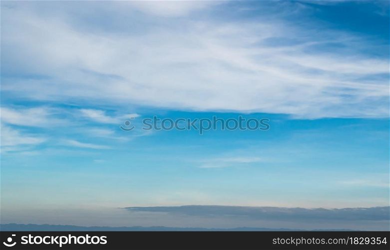 Blue sky against soft white clouds. Beautiful natural cloudscape background.