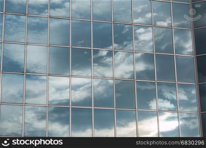 Blue Sky and Clouds Reflected in the Glass Building
