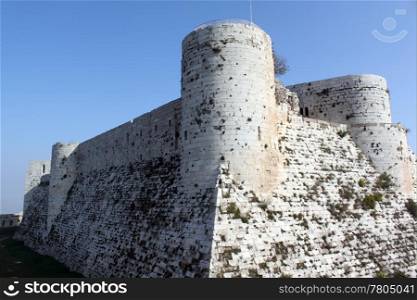 Blue sky and ruins of big stone castle Krak de Chevalier in Syria