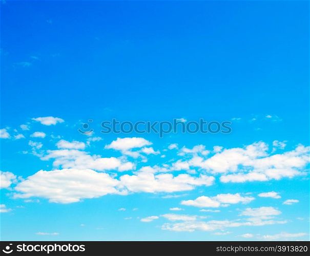 Blue sky background with a tiny clouds